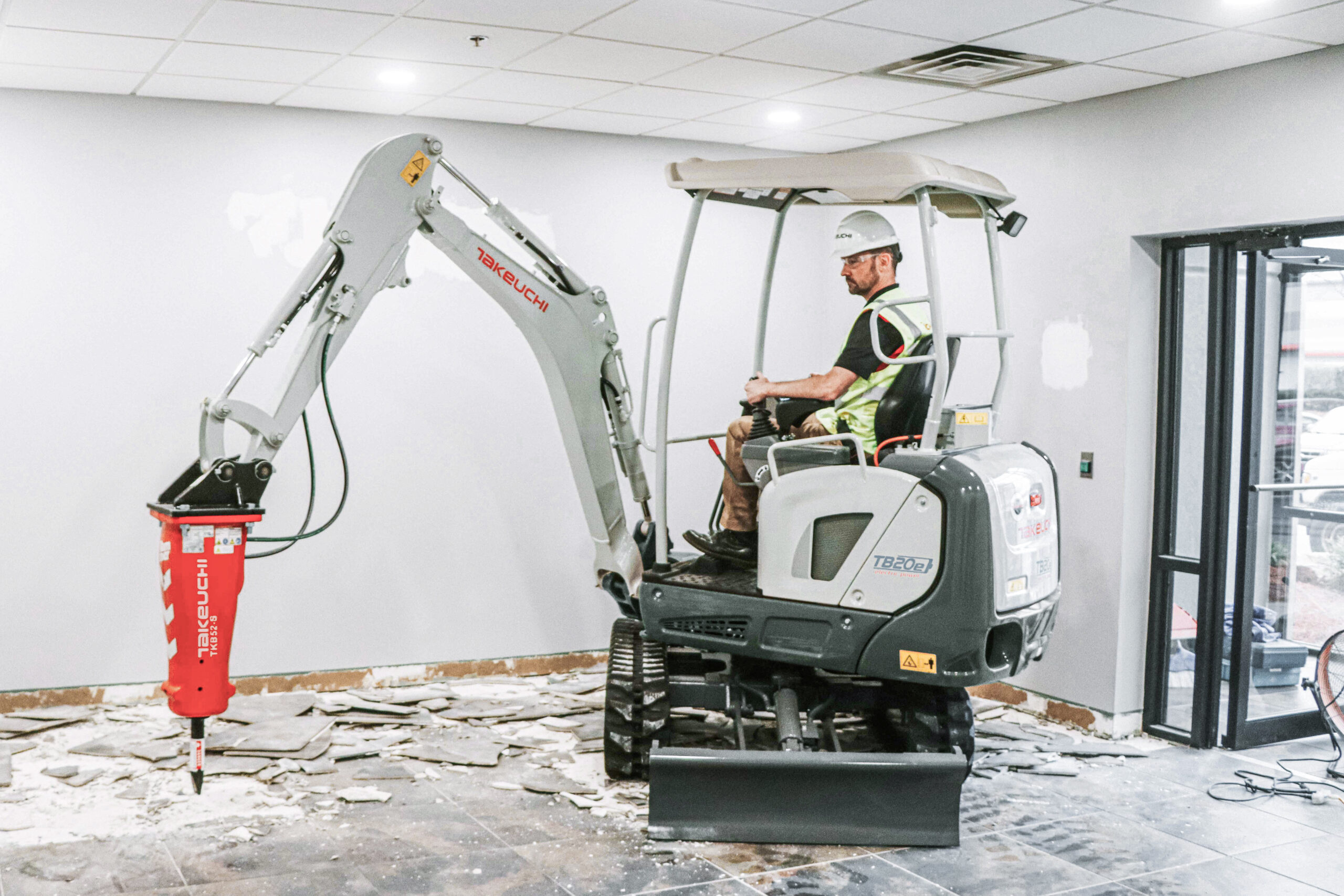 Man using a TB20e Compact Excavator with a Breaker